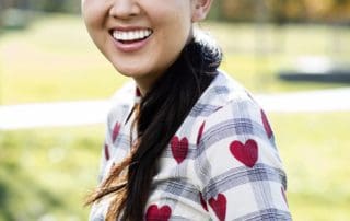 Teen girl posing with a beautiful smile, expressing pure joy after treatment at Pike District Smiles.