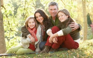 A family posing happily after receiving family dental services from Pike District Smiles.
