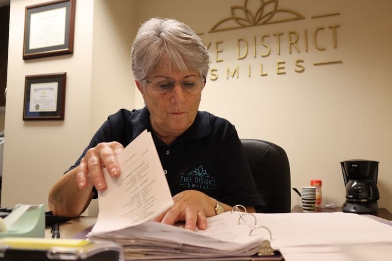 Dedicated staff arranging patient treatment records.