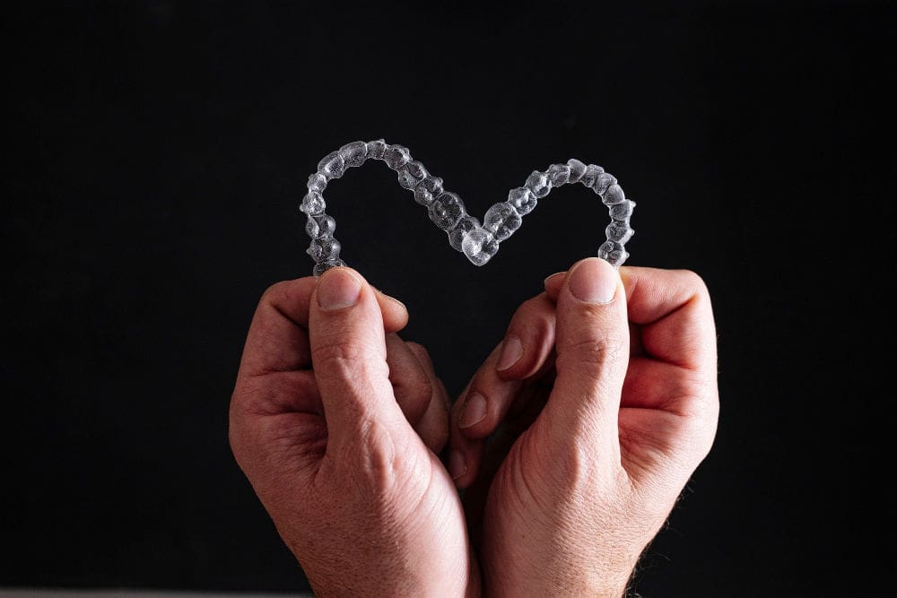 Rockville dentist | dentist holding Invisalign aligners.