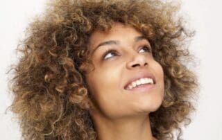 Woman smiling after successful dental implant treatment at Pike District Smiles.