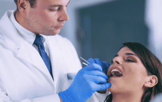 Dentist performing root canal treatment on patient.