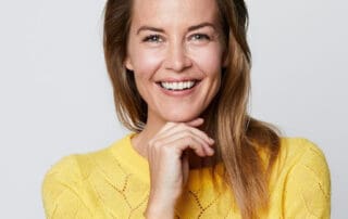 Proud female showing her teeth after brief dental treatment.