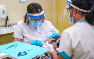 Two dentists providing sophisticated treatment to the patient.