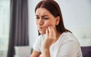 Worried patient experiencing mouth pain.