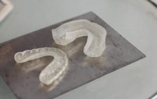 Invisalign aligners neatly arranged on a table.