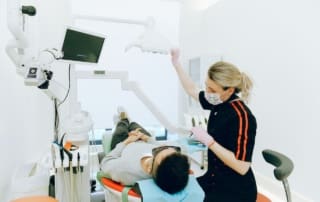 A dentist giving laser treatment to the client Pike District Smiles-Bethesda